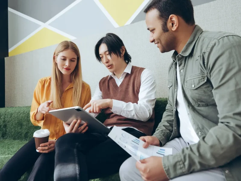 marketing-team-analyzing-data-and-working-on-digital-tablet-and-documents.jpg